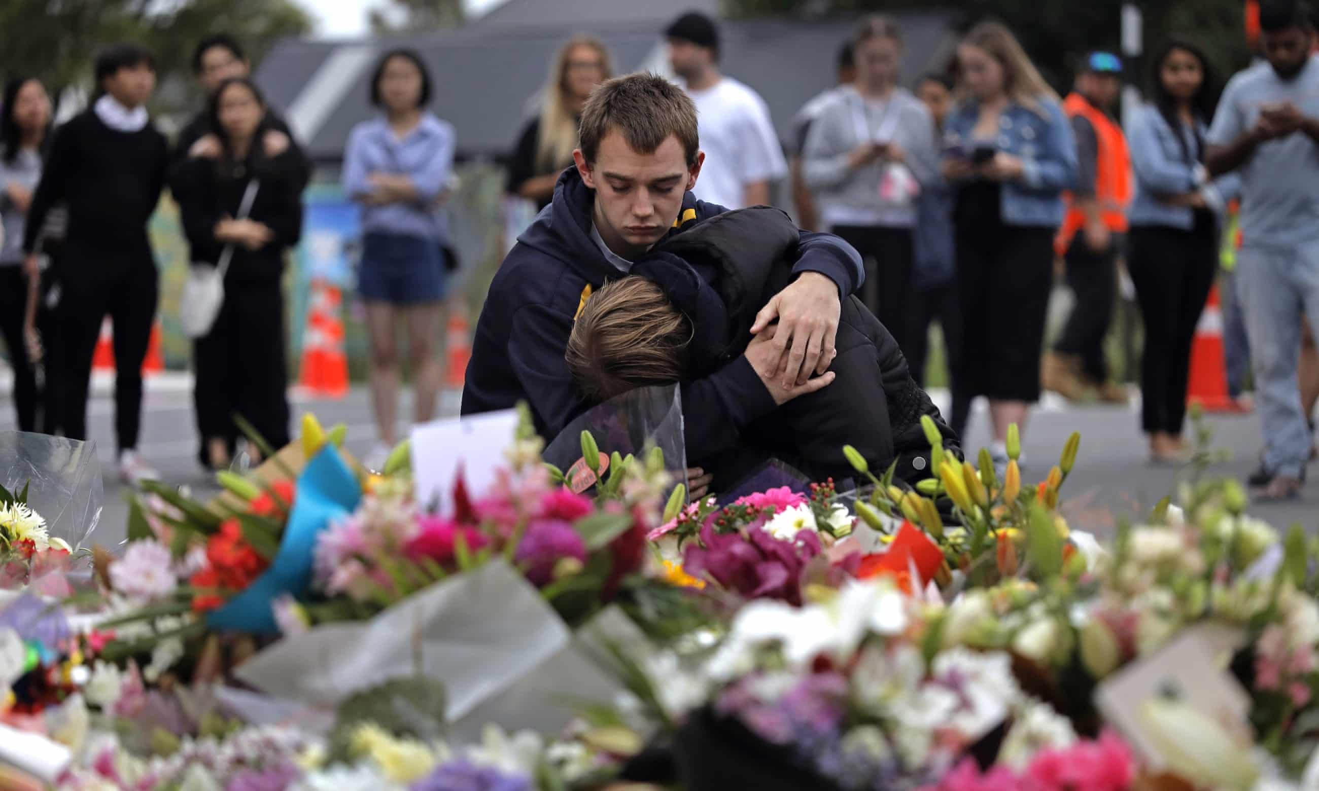 Mourners pay their respects at a makeshift memorial near Al Noor mosque in Christchurch. Photograph: Vincent Yu/AP